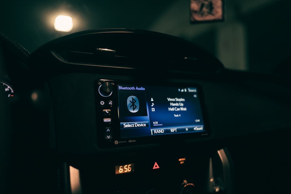 Close-up view of a car's dashboard at night displaying Bluetooth audio system. — Photo by Erik Mclean on Pexels